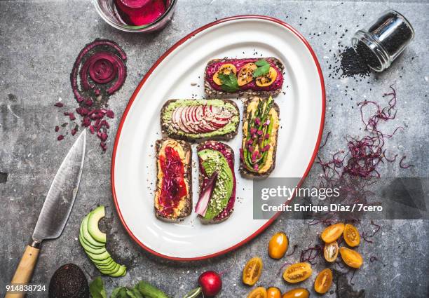 multicoloured hummus on toasts mis en place - seeded stock pictures, royalty-free photos & images