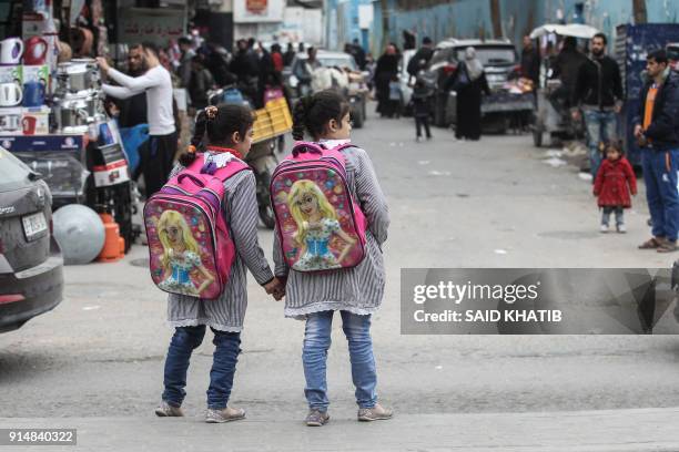 Palestinian school girls walk at the Rafah refugee camp in the southern Gaza Strip on February 6, 2018 after finishing their classes at a UN-run...