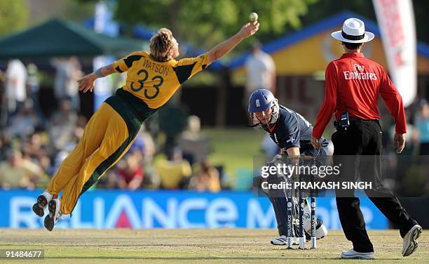 Australia's bowler Shane Watson jumps to stop a shot by England batsman Tim Bresnan as Luke Wright and Umpire Billu Bowden looks on during the ICC...