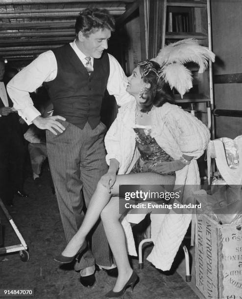 Actors Burt Lancaster and Janette Scott chatting backstage during a rehearsal for 'Night of 100 Stars' at the London Palladium, UK, July 1958.