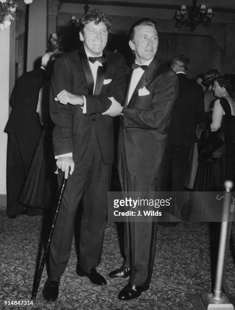American actors Burt Lancaster and Kirk Douglas arrive at the Leicester Square Theatre for the London premiere of the film 'The Vikings', 8th July...