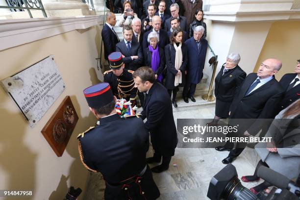 French President Emmanuel Macron places a wreath of flowers places a wreath of flowers during a ceremony in tribute to slain French prefect Claude...
