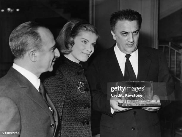 From left to right, director Alberto Lattuada, actress Gunnel Lindblom and director Federico Fellini at the premiere of the film 'The Silence' in...