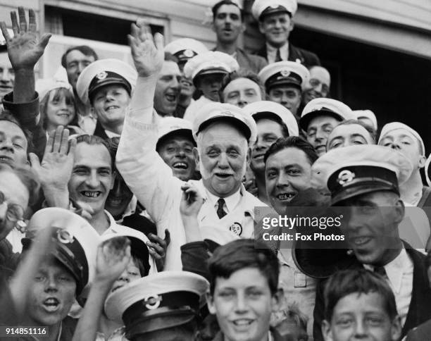 British Labour politician and social reformer George Lansbury , the MP for Bow and Bromley, helps London bus drivers entertain children at Theydon...