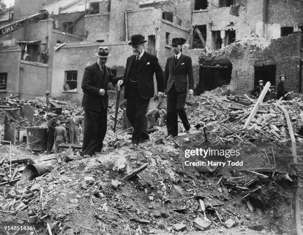 Sir John Dawson Laurie , the Lord Mayor of London, views a bomb-damaged site in Elephant and Castle, London, accompanied by Albert Joseph Gates, the...