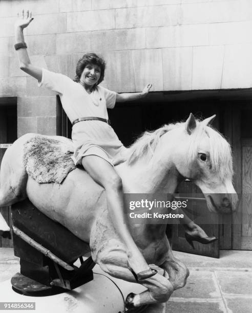 English broadcaster Sue Lawley riding a mechanical horse outside Broadcasting House in London, 4th June 1980. The horse was featured on Lawley and...