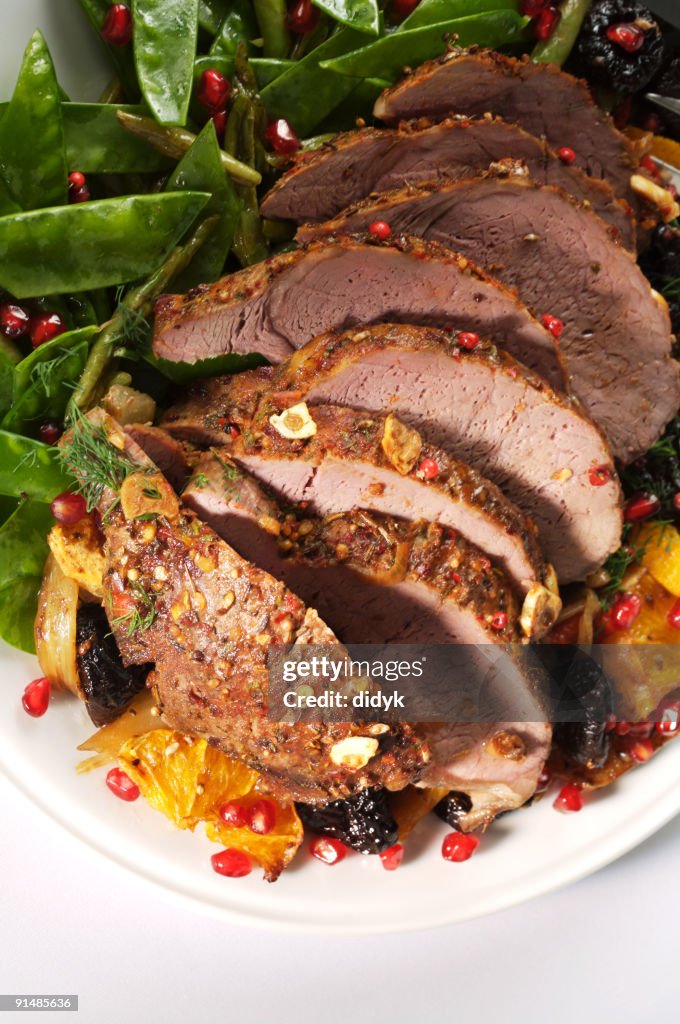 A Roast Cooked Christmas Lamb On A White Plays High-Res Stock Photo