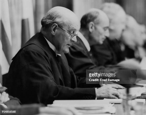 Lord Justice Geoffrey Lawrence , the British judge presiding at the Nuremberg Trials, reads part of the verdict in the Palace of Justice at...