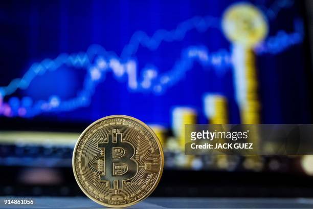 Picture taken on February 6, 2018 shows a visual representation of the digital crypto-currency Bitcoin, at the "Bitcoin Change" shop in the Israeli...