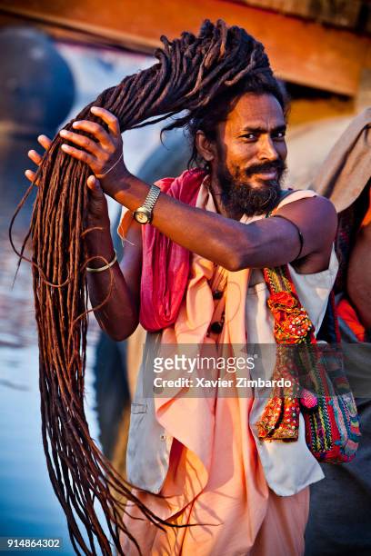 Sadhu styling his dreadlocks during the holy bath procession in the Maha Kumbh Mela on February 8th, 2013 at Allahabad, Uttar Pradesh, India