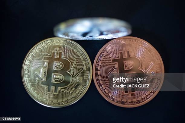Picture taken on February 6, 2018 shows a visual representation of the digital crypto-currency Bitcoin, at the "Bitcoin Change" shop in the Israeli...