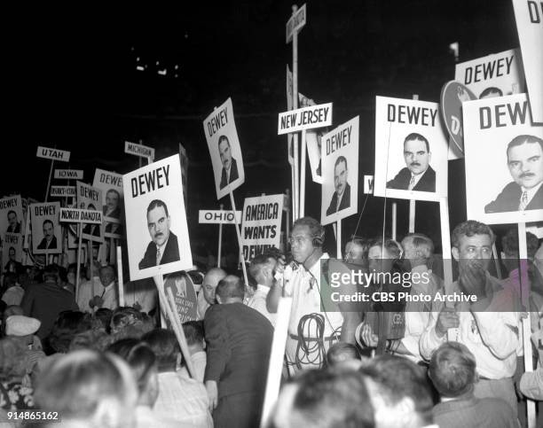 Radio covers the 1944 Republican National Convention, in Chicago, Illinois. June 27, 1944. Supporters hold signs featuring photo of Presidential...