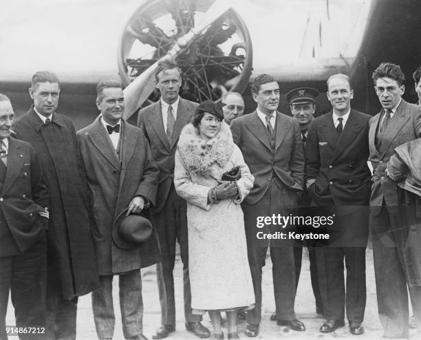 American aviator Charles Lindbergh poses with his wife Anne Morrow Lindbergh and various officials at Le Bourget Aerodrome in Paris, France, 31st...