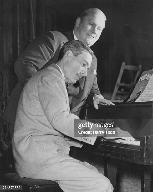 Impresario Carroll Levis listens to Hoagy Carmichael play the song 'Stardust' on the piano at the London Palladium, 30th March 1951. 'Stardust',...