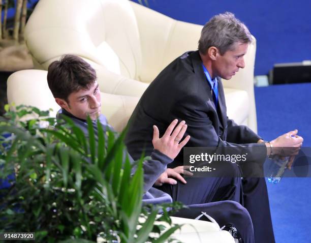 France's Brian Joubert waits for his score next to his coach Jean-Christophe Simond after his free skating program at the Dom Sportova Arena in...