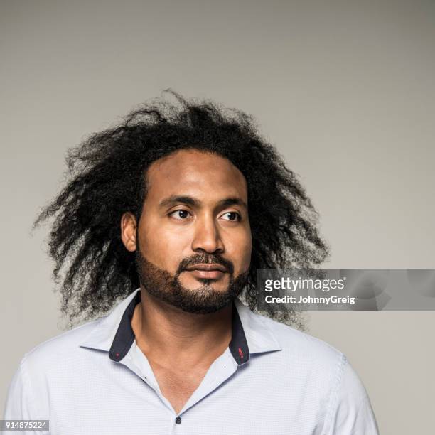 studio portrait of a mixed race man with afro hair - asian man long hair stock pictures, royalty-free photos & images
