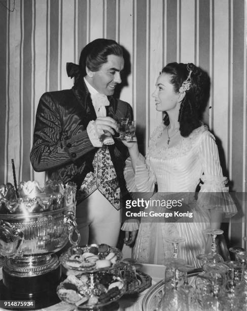Actors Tyrone Power and Ann Blyth in 18th century costume for a scene in the film 'The House on the Square' at Denham Studios, UK, 29th March 1951.