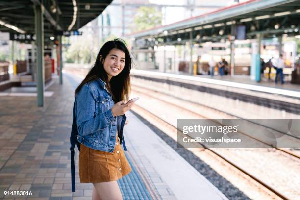 taking the train in sydney train station - asian skirts stock pictures, royalty-free photos & images