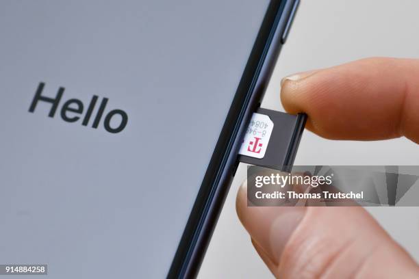 Berlin, Germany A SIM card from Deutsche Telekom is pushed into a smartphone on February 06, 2018 in Berlin, Germany.