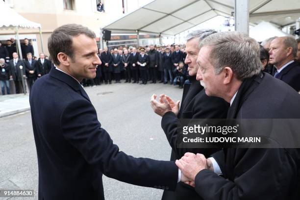 French president Emmanuel Macron shakes hands with Jean-Claude Grimaldi, former Erignac's driver during a ceremony in tribute to slain French prefect...