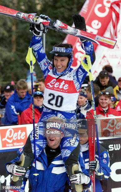 Christel Saioni of France is lifted on the shoulders of a team member as she celebrates her win in the women's World Cup slalom 20 November 1999 at...