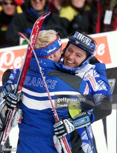 Christel Saioni of France gets a hug from a team member as she celebrates her win in the women's World Cup slalom 20 November 1999 at Copper...