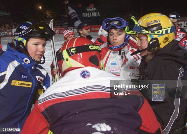 Swedish Anja Paerson, France's Christel Saioni and Swedish Pernilla Wiberg discuss with Austrian Sabine Egger after the first run of the women's...