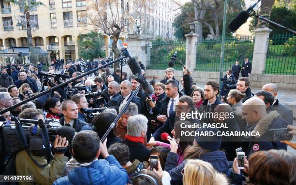 French president Emmanuel Macron, surrounded by media and people, shakes hands with supporters after a ceremomy in tribute to slain French prefect...