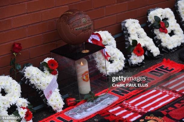 Flowers and momentos are left outside Old Trafford stadium during a ceremony to commemorate the victims of a plane crash 60 years ago, in Munich,...