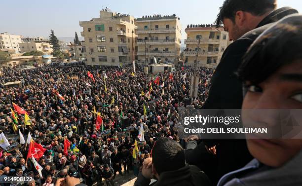 Syrian Kurds, Arabs, and Syriacs bussed in from across northern Syria demonstrate in the centre of the Kurdish city of Afrin on February 6 in a show...