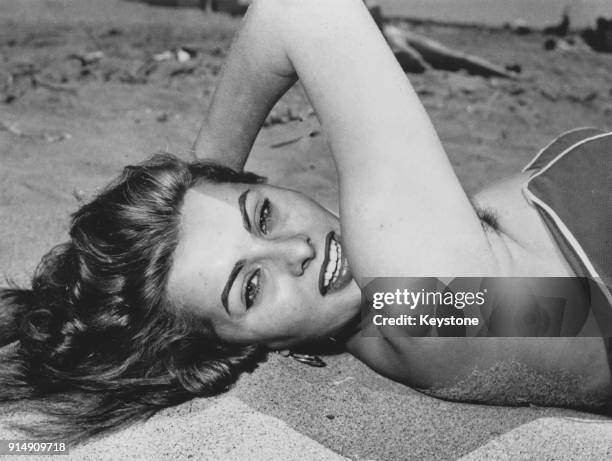 Italian actress Sophia Loren relaxes on a beach in Italy, June 1954.