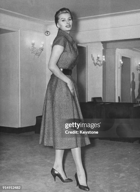 Italian actress Sophia Loren tries on a Christian Dior 'New Line' dress made by Battilocchi of Rome, in a store in Rome, Italy, 6th February 1956.