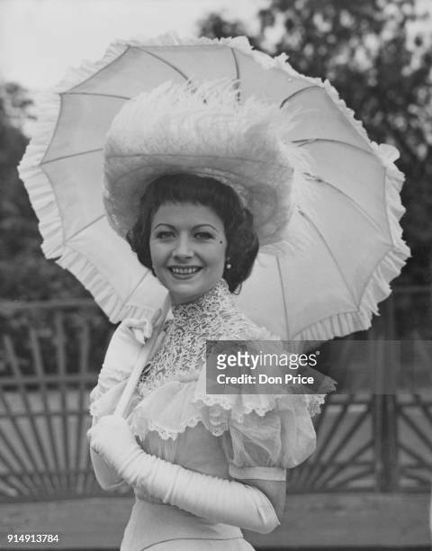 English actress Margaret Lockwood wearing period fashion to the Theatrical Garden Party at the Chelsea Royal Hospital, London, part of the Chelsea...