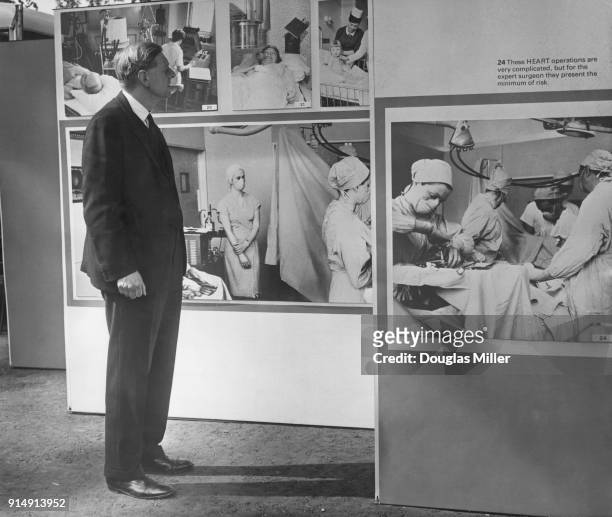 British consultant heart surgeon Donald Longmore visits an exhibition of photographs on open heart surgery at the Royal College of Physicians in...