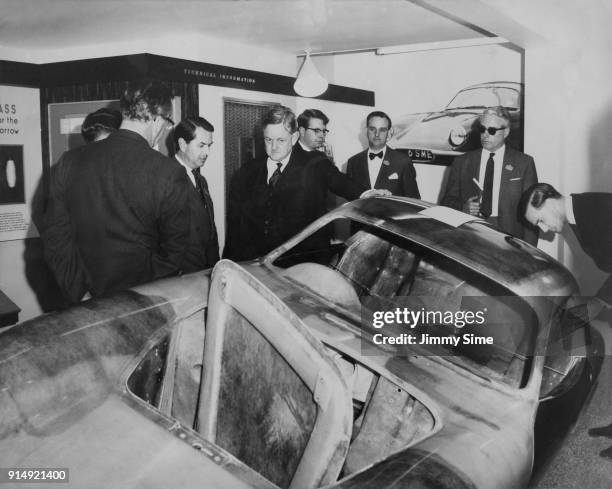 Conservative politician Quintin Hogg, 2nd Viscount Hailsham , the Minister for Science, examines the fibre-glass reinforced body of a Lotus Elite...