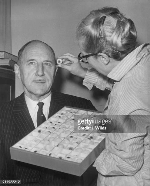 Joseph Luns , the Dutch Foreign Minister, sits for Vera Bland to pick out the correct eye colour for his waxwork at Madame Tussauds in London, 17th...