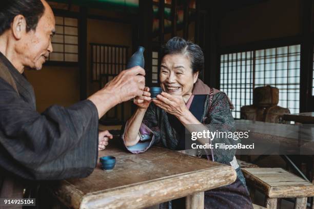 japanese couple in a traditional house - sake stock pictures, royalty-free photos & images