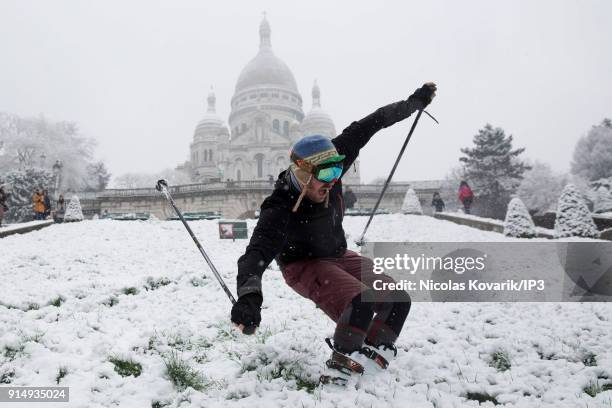 Man skis on Montmartre Hill near the Sacre Coeur during a snowfall on February 6, 2018 in Paris, France. Several french departments are affected by a...