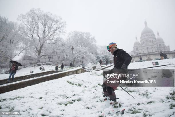 Man does ski on Montmartre Hill near the Sacre Coeur during a snowfall on February 6, 2018 in Paris, France. Several french departments are affected...