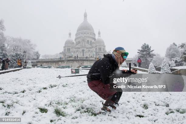 Man skis on Montmartre Hill near the Sacre Coeur during a snowfall on February 6, 2018 in Paris, France. Several french departments are affected by a...