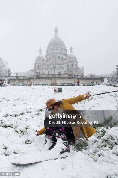 Woman skis on Montmartre Hill near the Sacre Coeur during a snowfall on February 6, 2018 in Paris, France. Several french departments are affected by...