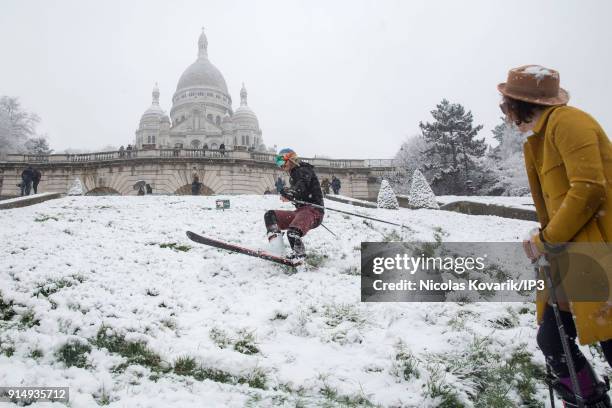 Man skis on Montmartre Hill near the Sacre Coeur during a snowfall on February 6, 2018 in Paris, France. Several french departments are affected by a...