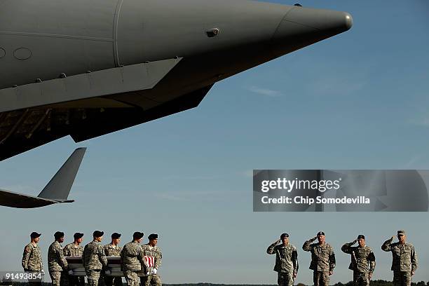 Air Force Colonel Robert Edmondson, U.S. Army Sgt. Maj. Dailey, Maj. Gen. David Perkins and Lt. Gen. David Huntoon salute as soldiers carry the...