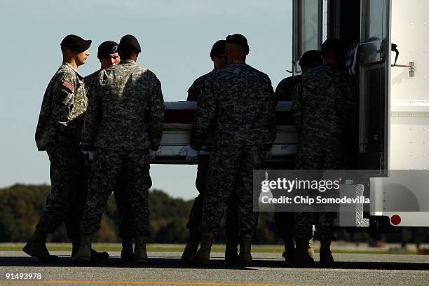 Army soldiers load the flag-draped transfer case containing the remains of U.S. Army Private First Class Kevin C. Thomson of Reno, Nevada, into a...