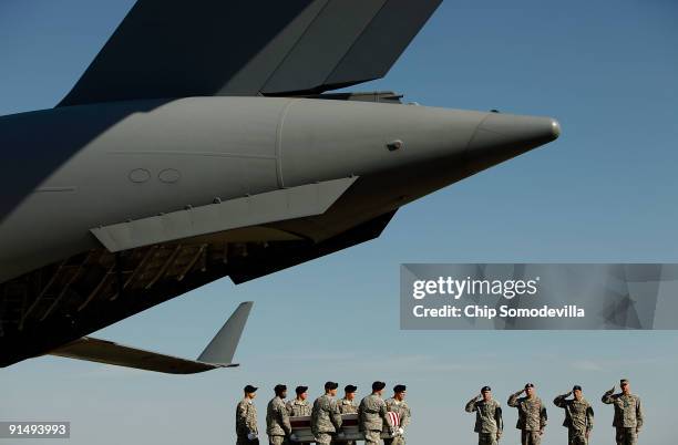 Air Force Colonel Robert Edmondson, U.S. Army Sgt. Maj. Dailey, Maj. Gen. David Perkins and Lt. Gen. David Huntoon salute as soldiers carry the...