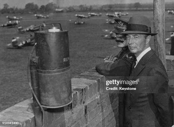 Robert A. Lovett , the US Assistant Secretary of War for Air, watches fighter planes take off from a P-47 fighter station in Britain, during a tour...