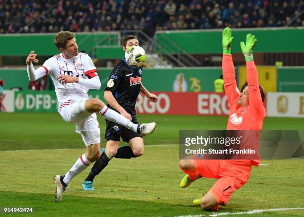 Thomas Mller of Muenchen is challenged by Michael Ratajczak of Bielefeld during the DFB Pokal quater final match between SC Paderborn and Bayern...