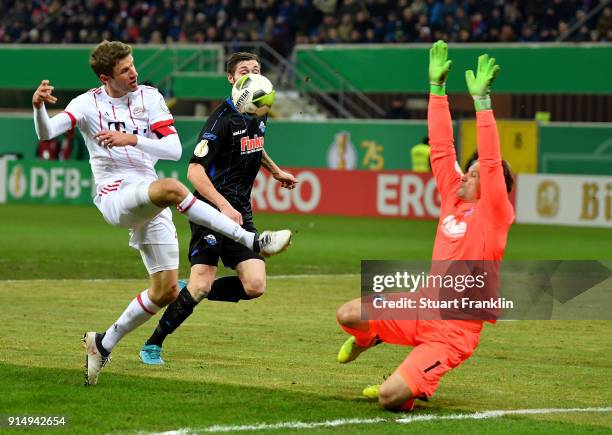 Michael Ratajczak , goalkeeper of Paderborn makes a safe on Thomas Mueller of Muenchen during the DFB Cup quarter final match between SC Paderborn...