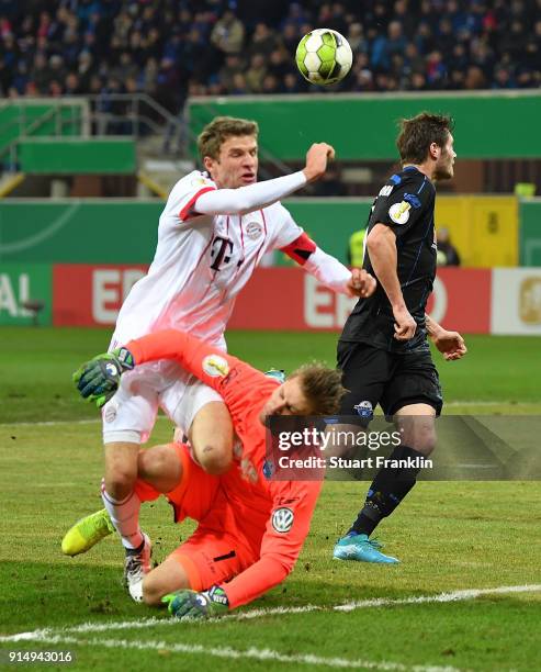 Thomas Mller of Muenchen is challenged by Michael Ratajczak of Bielefeld during the DFB Pokal quater final match between SC Paderborn and Bayern...