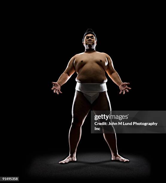 pacific islander sumo wrestler standing with open hands - sumo wrestling stock pictures, royalty-free photos & images